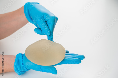 A plastic surgeon shows a breast silicone implant.