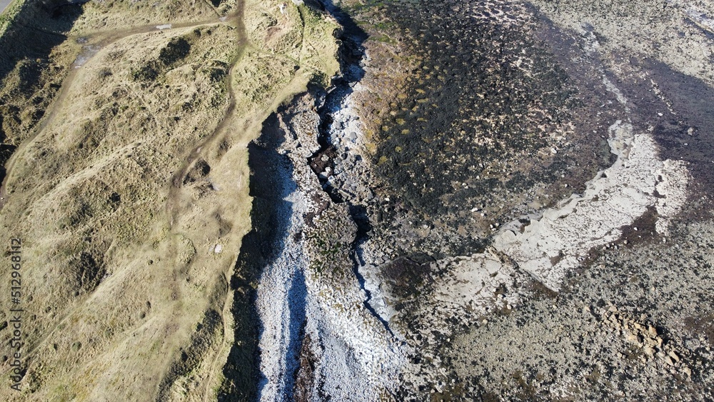 Aerial view looking straight down onto a rocky coastline with waves crashing. Taken in Dunbar Scotland. Aerial view looking straight down onto a rocky coastline with waves crashing. Taken in Dunbar Scotland.