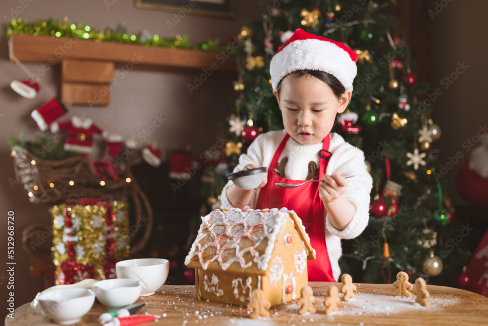 young girl making gingerbread house at home young girl making gingerbread house at home
