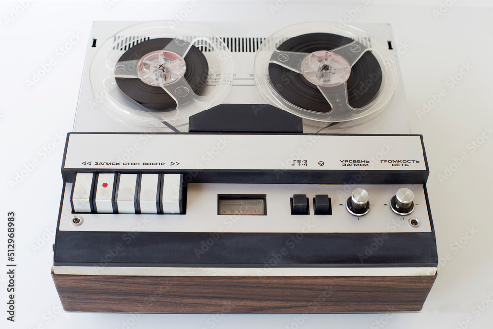 Obraz premium old-style reel-to-reel tape recorder, with inscriptions (record, stop, play, volume, network, level,) selective focus, close-up on a white background