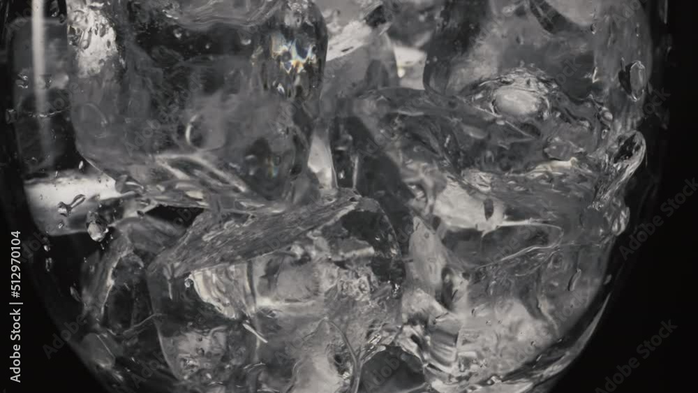 Ice cubes moving empty glass closeup. Refreshing cocktails making concept Ice cubes moving empty glass closeup. Refreshing cocktails making concept