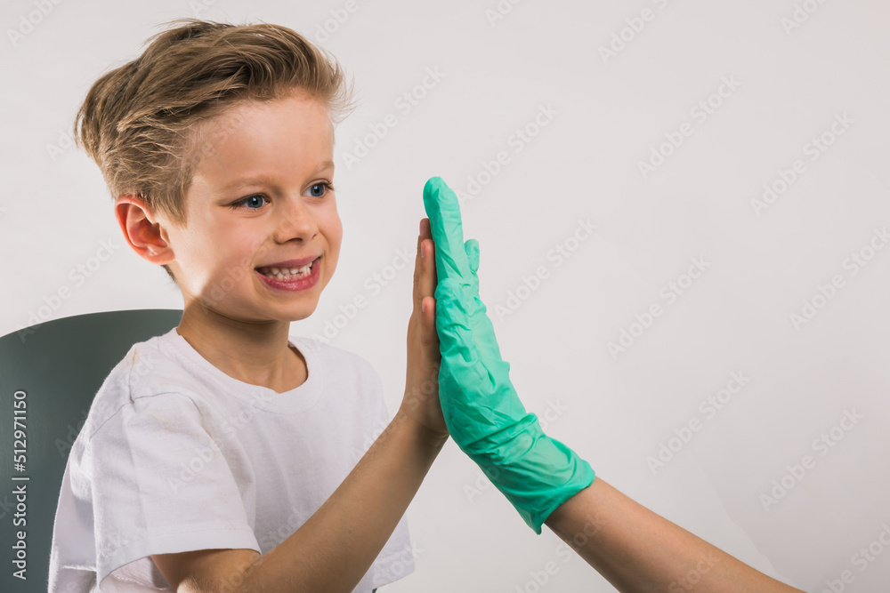 Cheerful great doktor giving his little patient a high five Cheerful great doktor giving his little patient a high five