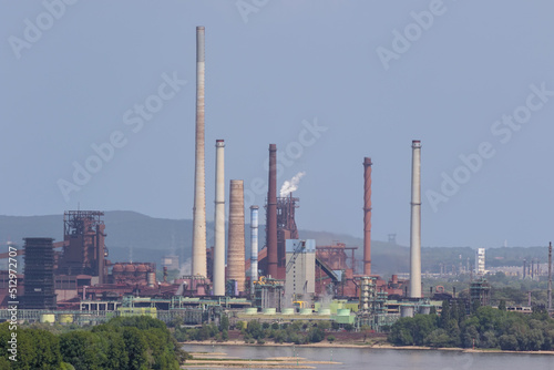 Close up of a blast furnace and coking plant next to the Rhine, seen from the Halde Rheinpreussen near Duisburg. The landscape behind the plant is blurred due to the heat radiation from the plant.