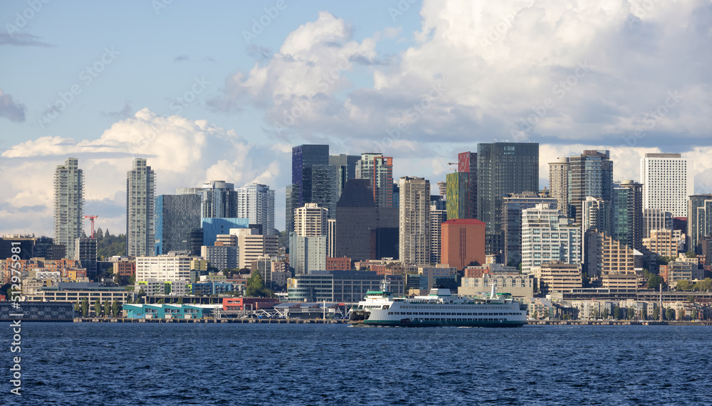 Downtown Seattle, Washington, United States of America. Panoramic View of the Modern City and Ferry Boat on the Pacific Ocean Coast. Cloudy Blue Sky.