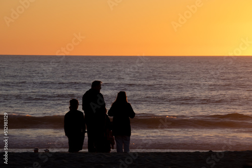 Family at the beach at sunset