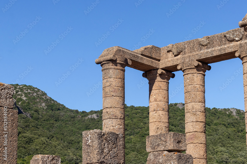 Close up view of antique Roman temple with copy space and the mountains behind