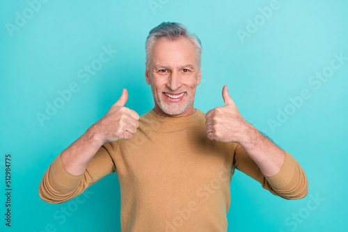 Photo of positive friendly person two hands fingers show thumb up isolated on teal color background © deagreez