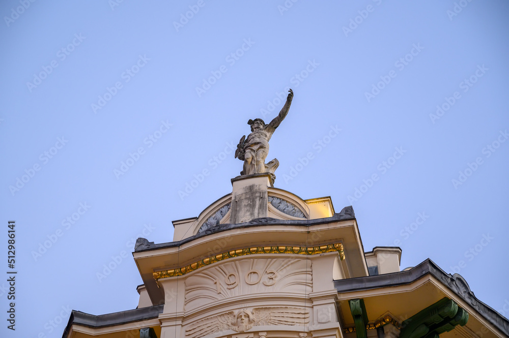 Obraz premium A statue of the Roman god Mercury on the top of Ljubljana's luxury department store Galerija Emporium