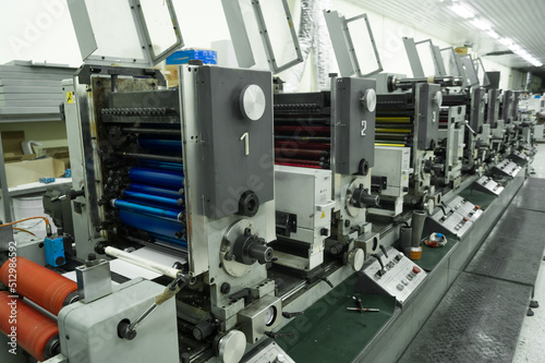 Used modern multi-color roll printing machine for the production of self-adhesive labels. Equipment for printing house. Selective focus © Иван Решетников