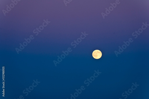 Full moon against blue sky