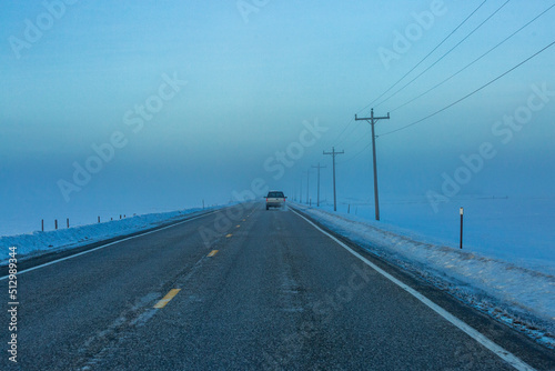 USA, Idaho, Fairfield, Car heading into fogbank along Highway 20 in winter photo