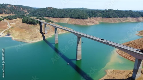 Aerial fly Calaveras County, California, now submerged beneath a reservoir named New Melones Lake. Flight over a large bridge over a reservoir in California National Park photo