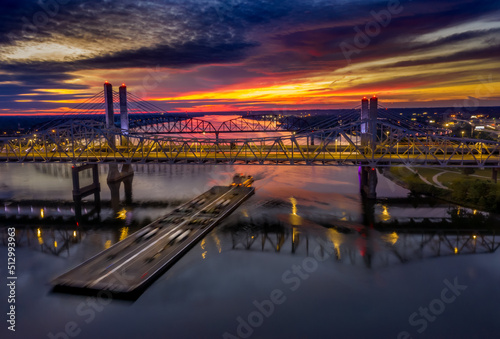 Valokuva Bird's eye shot of a river barge sailing under a bridge in Ohio river at sunrise