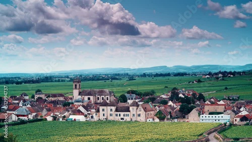 Time lapse of clouds moving over summer vineyards landscape and village Pommard. Burgundy road. Cote de Beaune, Cote d'Or, France. photo