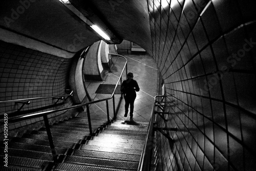 Photo Descending one step at time in a dark tunnel.