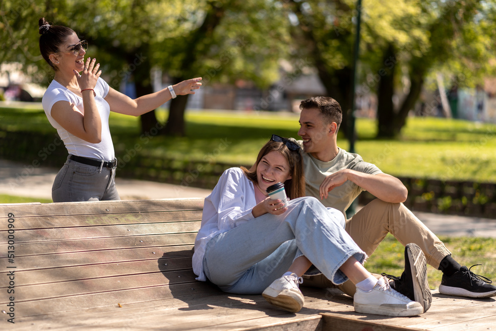 Three young adults talking together having fun Three young adults talking together having fun