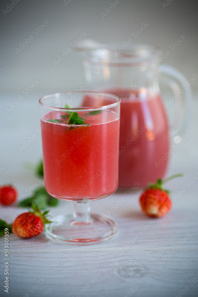 Cold summer strawberry kvass with mint in a glass Cold summer strawberry kvass with mint in a glass