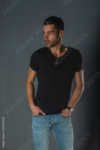 Close-up portrait of a handsome male model an with a beard wearing black shirt