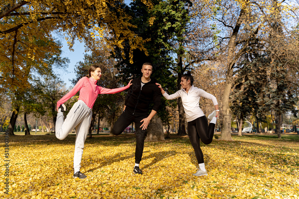 Fototapeta premium Stretching together and smiling in the park