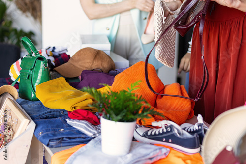 Fotografie Young women at swap home party - clothes, shoes, bags, jewellery exchange between friends