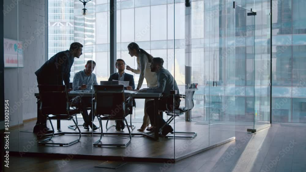 Group of business partners discussing company development strategy in modern office