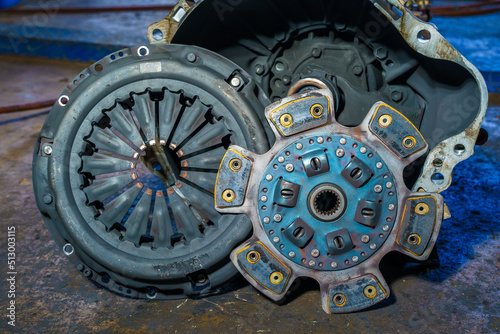 clutch plate and Clutch Cover expire on background gear transmission.Old Metallic clutch on Truck clutch system