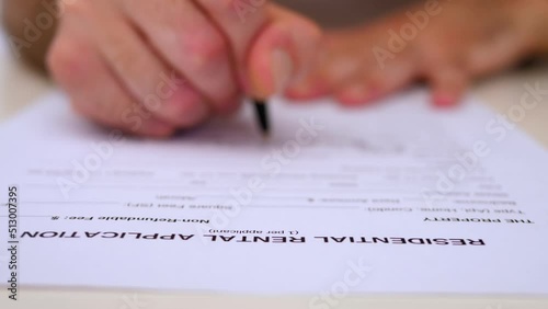 hand of man enters data in the residential rental application in the US