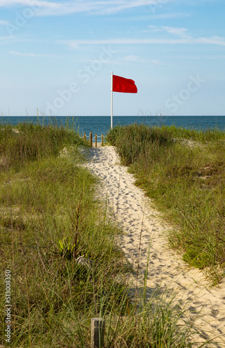 Red flag riptide warning on the beach