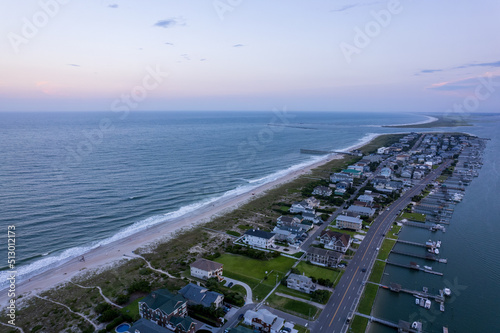 Bird's eye view of houses on a peninsula against a seascape at sunset photo