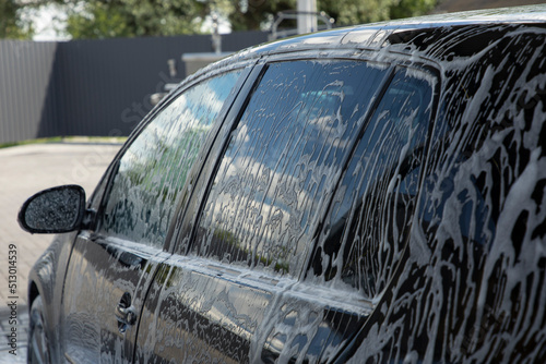 Black car being washed at a car wash