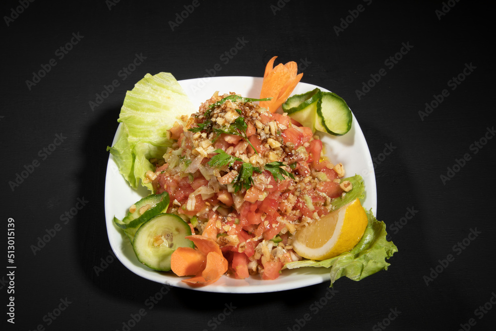 Nutritious simple salad plate with green vegetables, walnuts, onions and oil, top view, space for text Nutritious simple salad plate with green vegetables, walnuts, onions and oil, top view, space for text