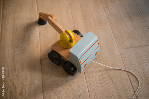 Wooden truck on pavement with cotton cord