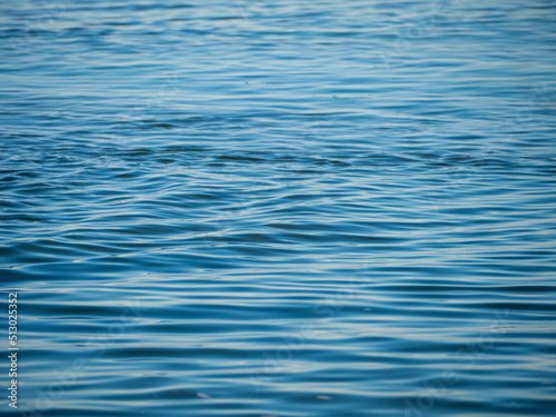 Fototapeta Naklejka Na Ścianę i Meble -  Blue sea water background texture. Sea background. Selective focus on center of image. Blue Water Background