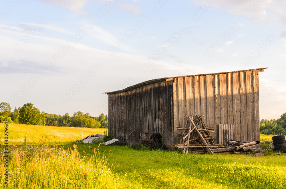 A farmer's old barn near a field A farmer's old barn near a field