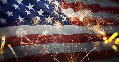American flag waving with fireworks celebrating 4th of July