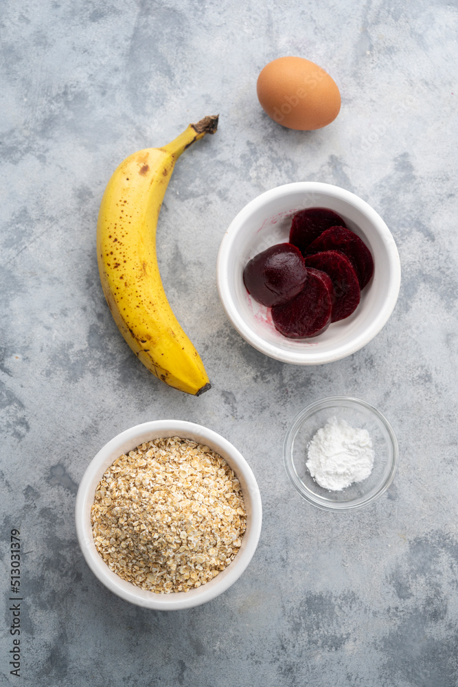 Ingredients for beetroot pancakes, banana, oats, an egg, beetroot. Top view. Cooking healthy food. Ingredients for beetroot pancakes, banana, oats, an egg, beetroot. Top view. Cooking healthy food.