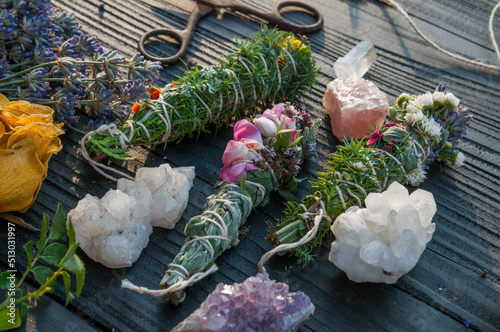 Smudge sticks and crystals on a black wooden table photo