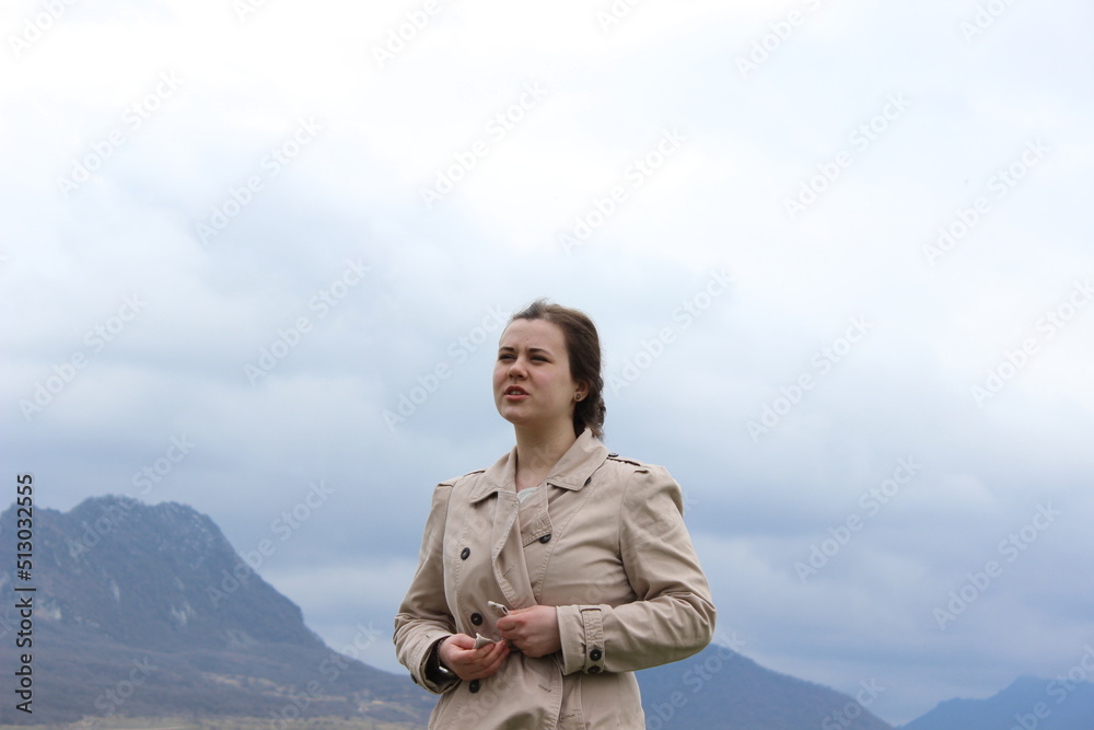 A girl of European appearance in nature, in the mountains.