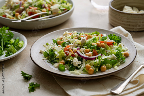 Cabbage green salad. Healthy fresh salad with tomatoes, parsley, onions, salad cheese, chickpeas. Detox, healthy food