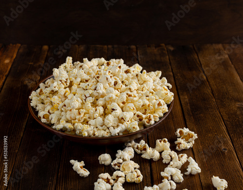 A bowl of delicious popcorn on a wooden table