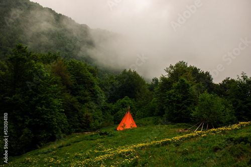 The ethical dwelling of the Indians in the mountains on a green meadow.
