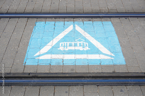 tram signal painted on the road between tram tracks. sustanable and electric transport concept photo