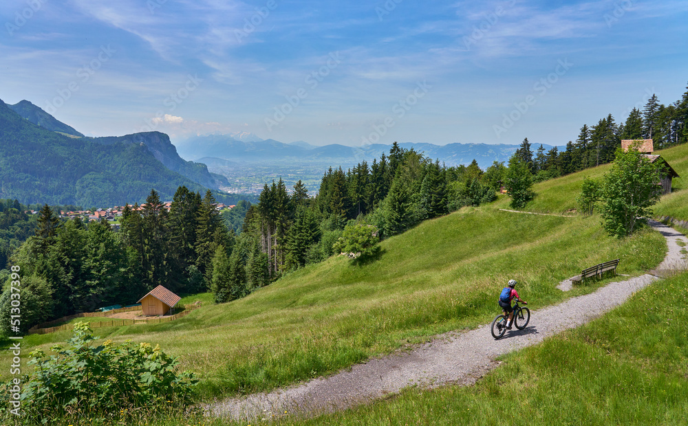 nice senior woman riding her electric mountain bike  in the Bregenzer Wald mountain range above Dornbirn and Rhein valley, in Vorarlberg, Austria