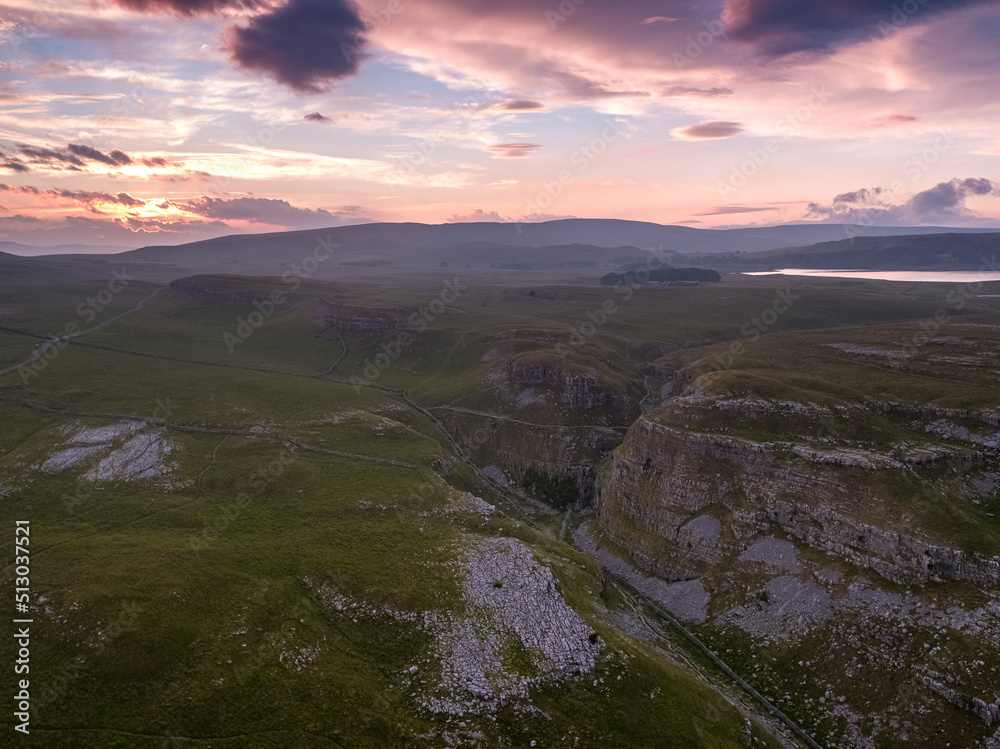 Sunset over the limestone landscape of Comb Ill near Malham Cove and Malham Tarn where the Pennine Way takes its route down the Dry Valley, Yorkshire Dales National Park