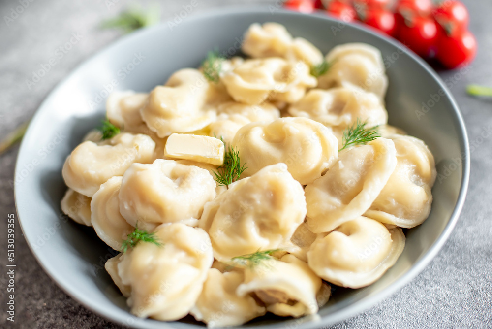 Homemade dumplings with meat - Russian dumplings. Dumplings with meat filling, ravioli on a stone background Homemade dumplings with meat - Russian dumplings. Dumplings with meat filling, ravioli on a stone background
