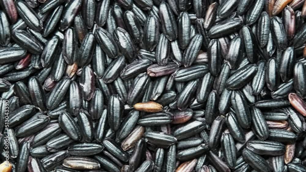 top view of scattered shelled black glutinous rice on the table. abstract food background. top view of scattered shelled black glutinous rice on the table. abstract food background.
