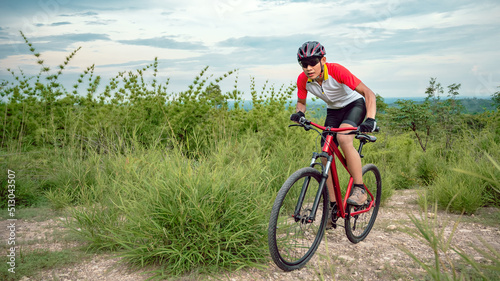 Mountain bikers ride MTB, mountain bike downhill to the extreme. Asian man rides MTB, mountain bike downhill in the wild to extremes. Extreme Sport and MTB, mountain bike downhill Concept.