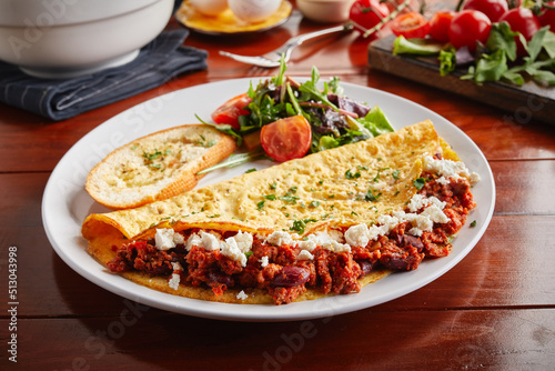 Chili Beef shawarma wrap served in a dish isolated on wooden background side view