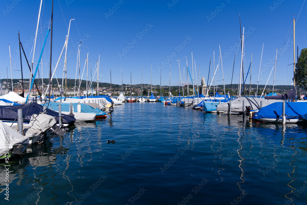 Enge port at City of Zürich with sailing boats and masts on a sunny summer day. Photo taken June 11th, 2022, Zurich, Switzerland.