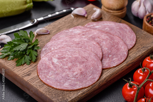 Slices of delicious fresh sausage on a wooden cutting board